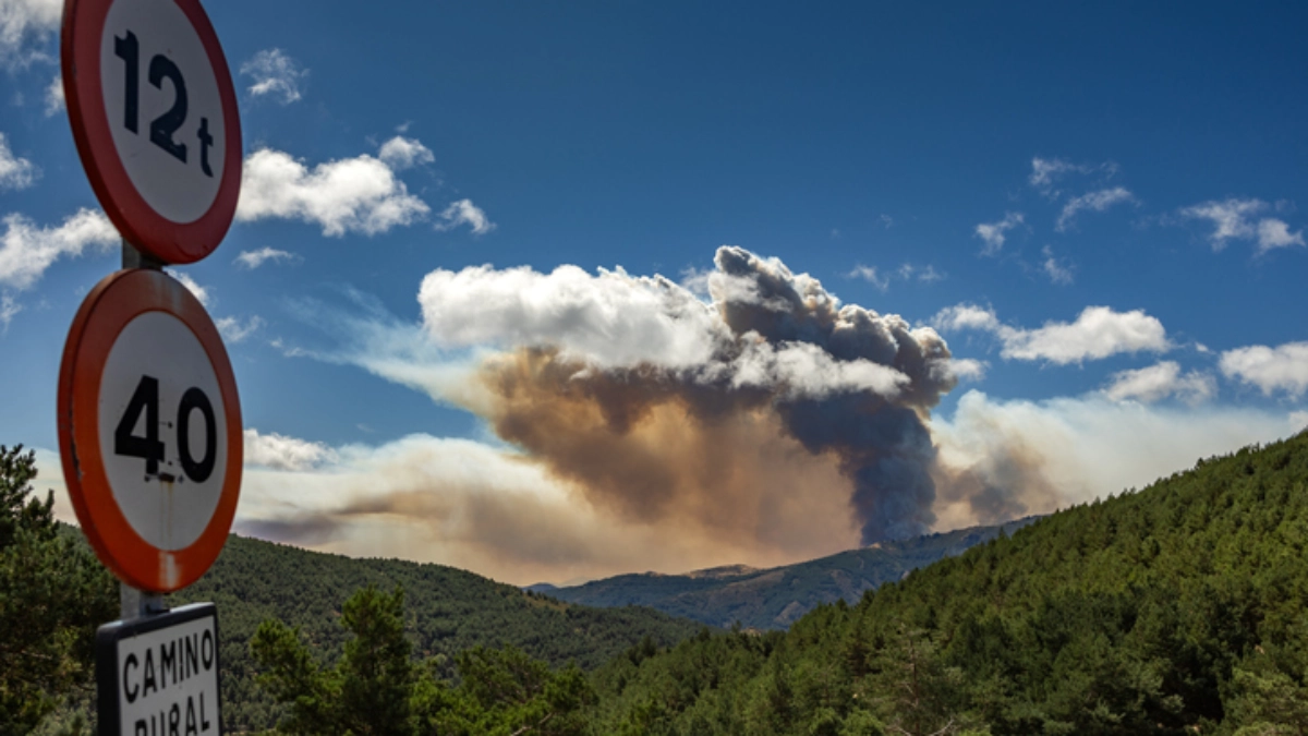 an image of a wildfire smoke in a distant hillside in spain