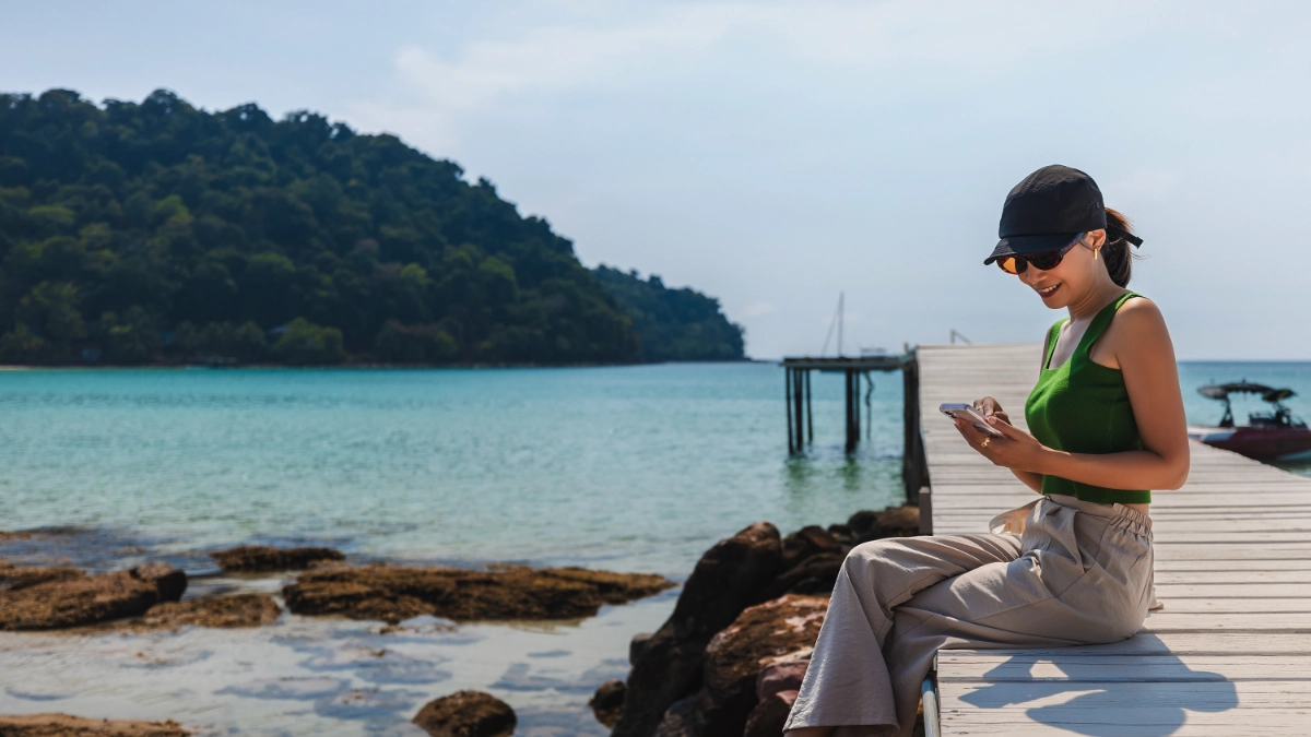 Traveler relaxing on a wooden pier at Bang Bao Beach, Thailand