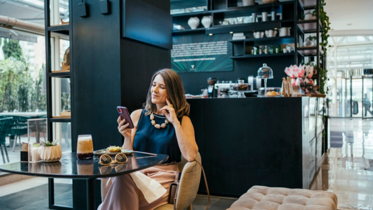 person using phone hotel lobby