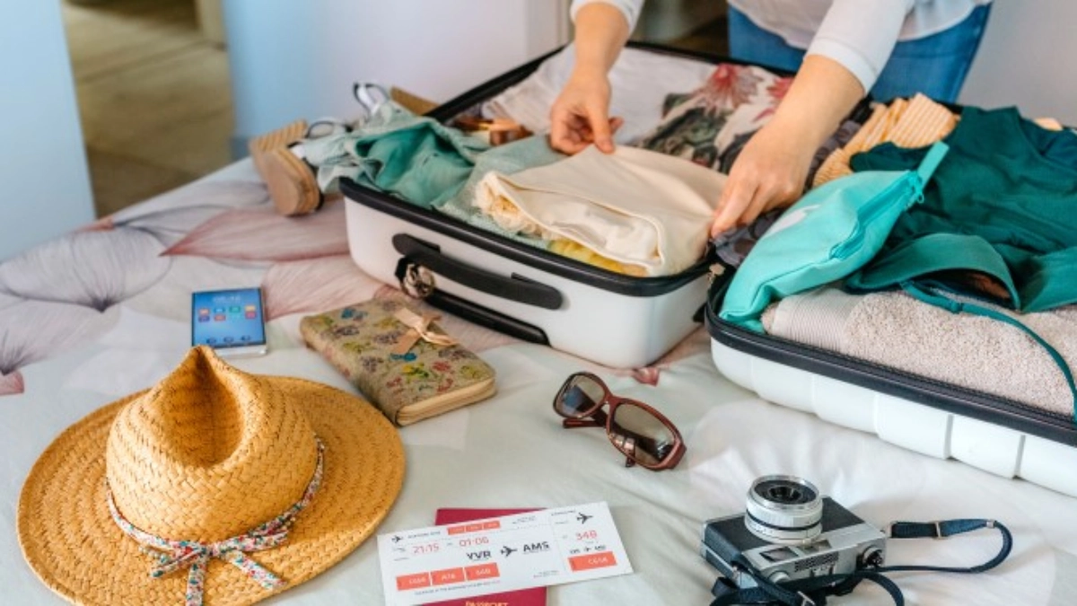 Image of a woman packing a suitcase to travel
