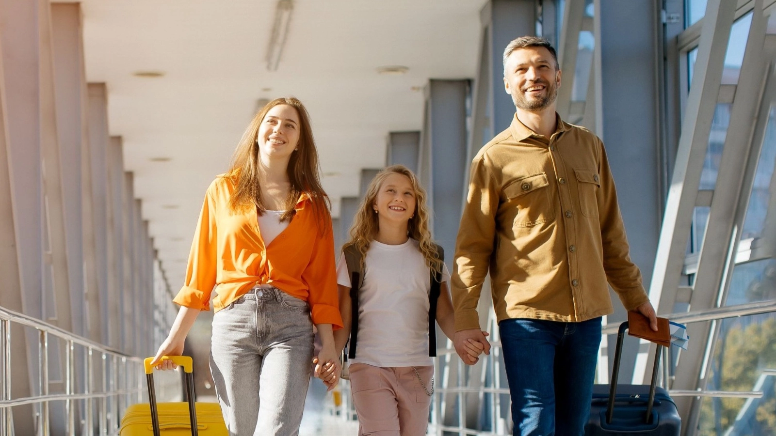 A family walking together at airport with luggage