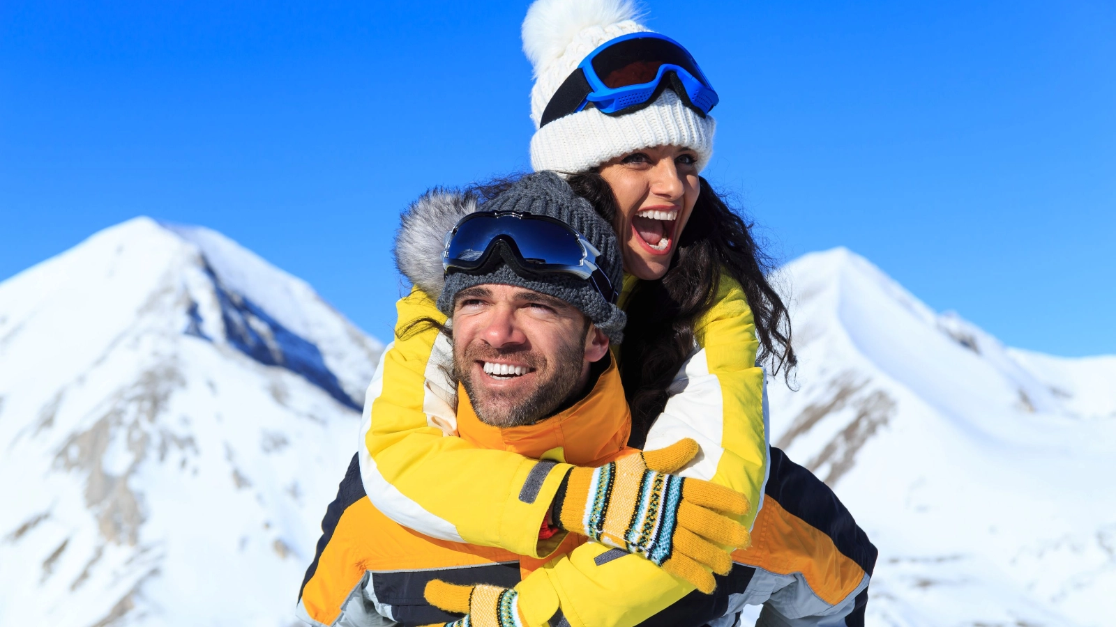 Couple skiers having fun on top snow mountain