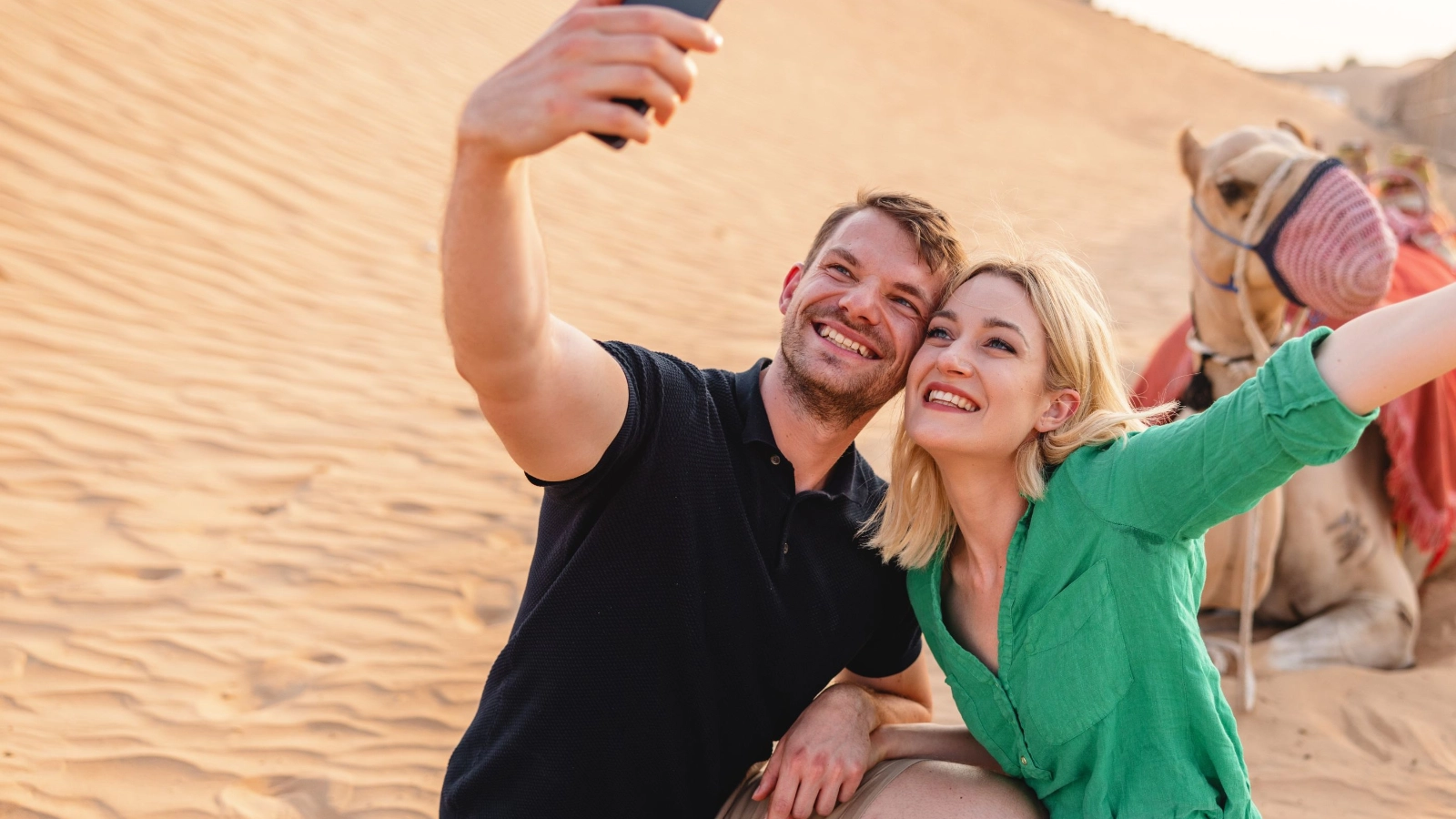 Young Adult Tourists Taking A Selfie With A Camel In Dubai