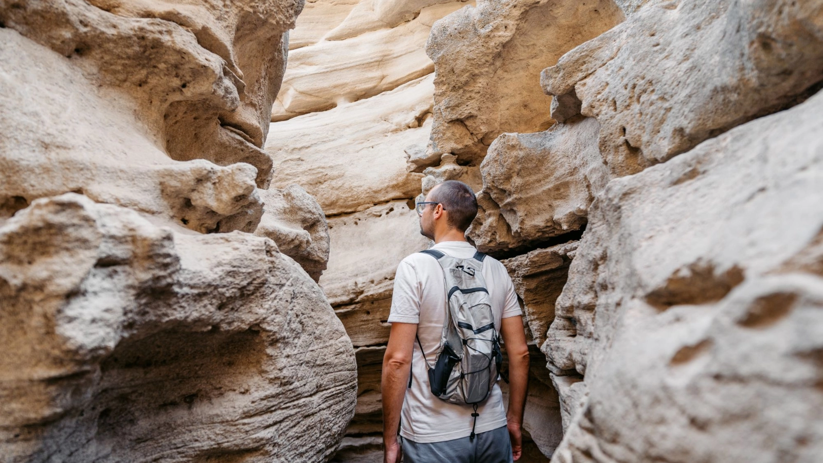 Man exploring The 12 Voltas Slot Canyon in Cape Verde