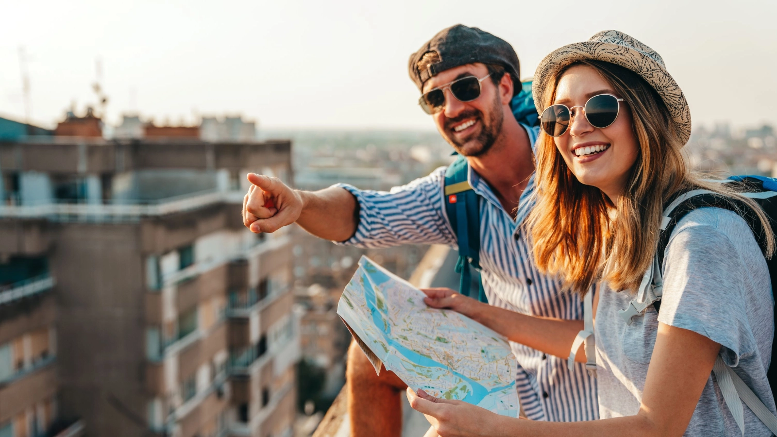 Couple sightseeing city with map together.