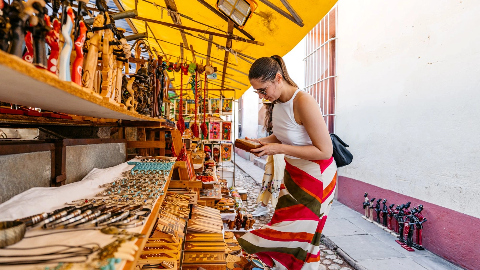 Woman shopping for souvenirs on the street in trinidad in cuba