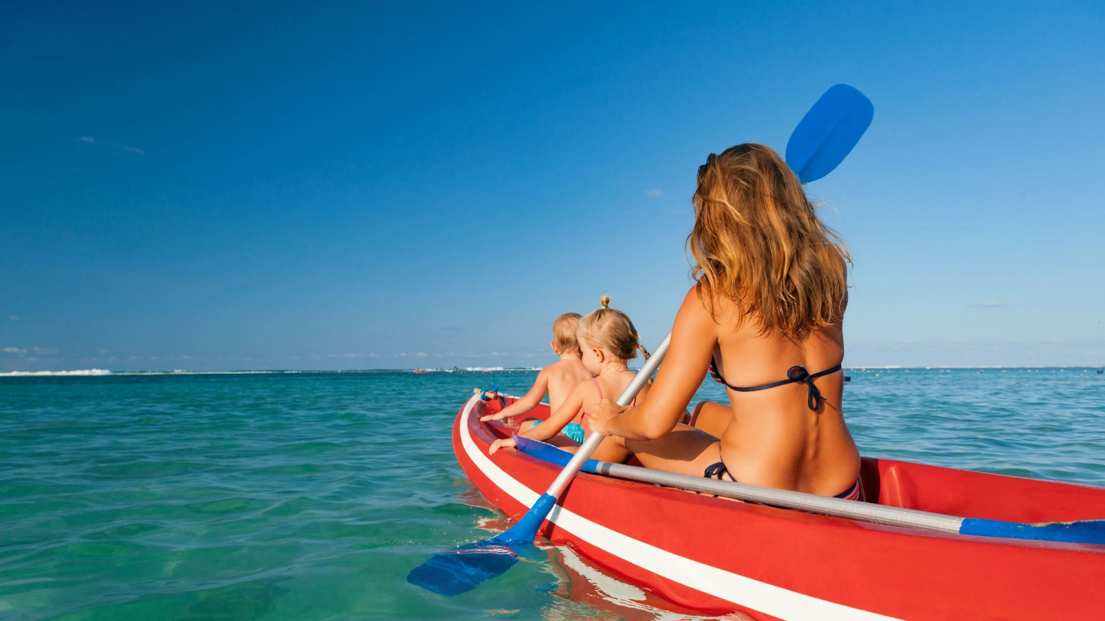young mother, children have fun on boat walk