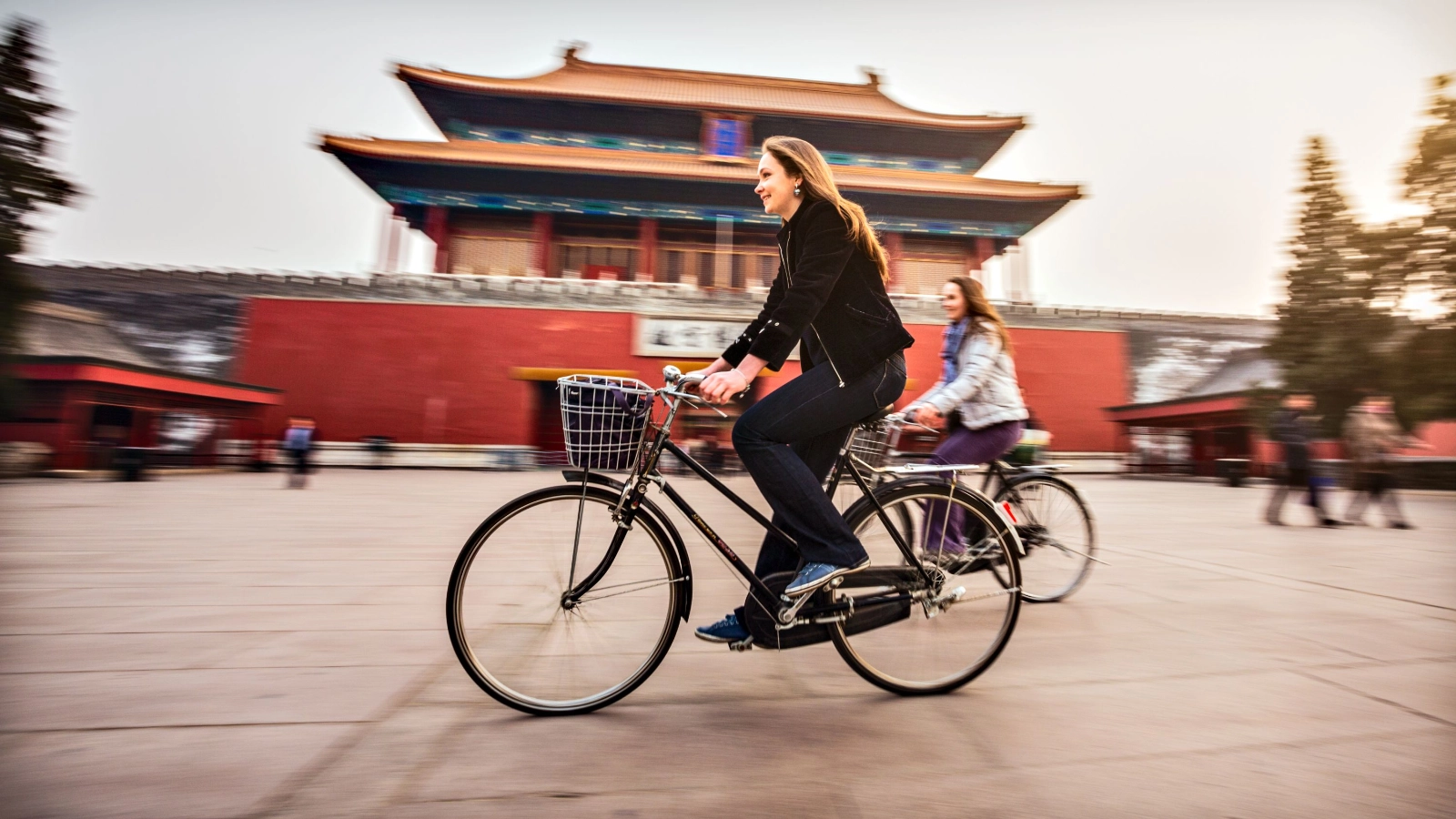 Tourists in Beijing riding bikes