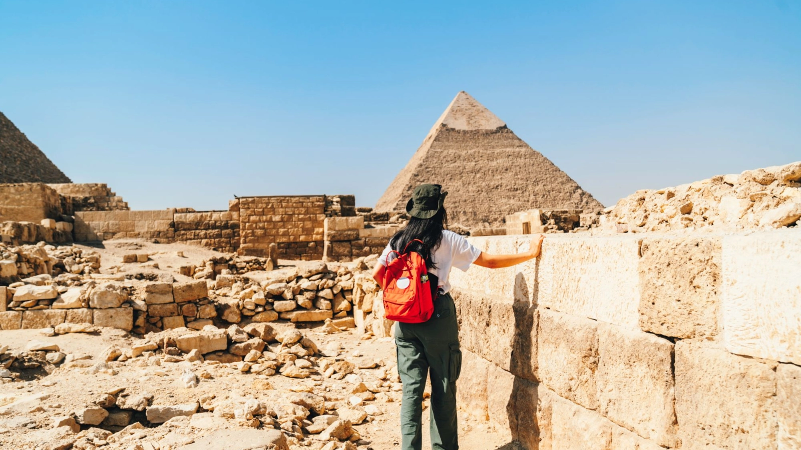 A traveller walking by the pyramid pharaoh in Giza Cairo