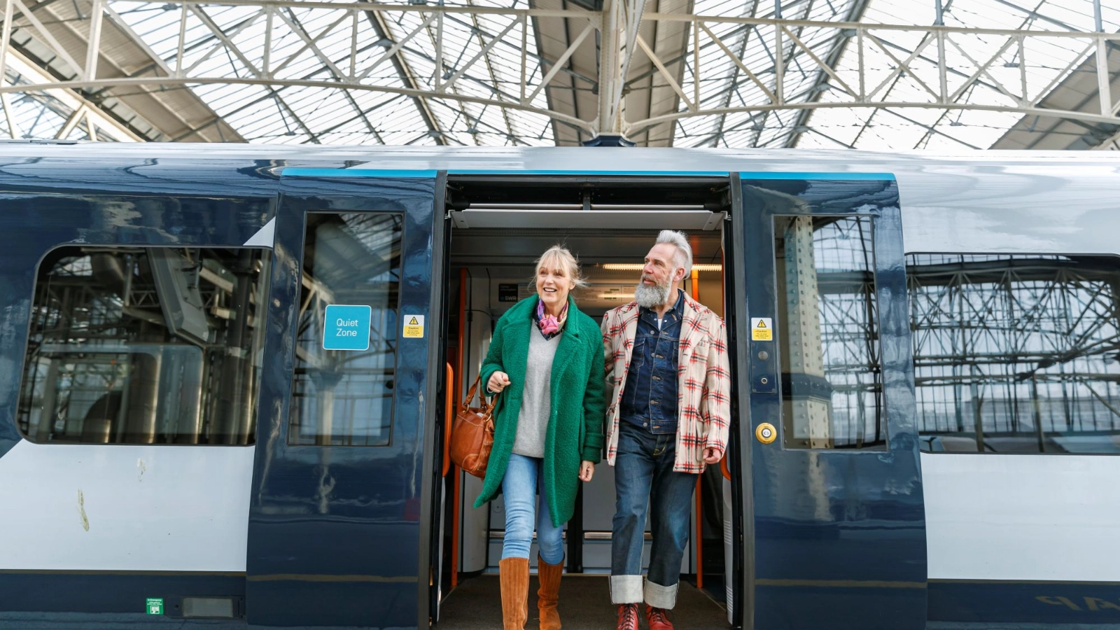 Senior couple exiting train