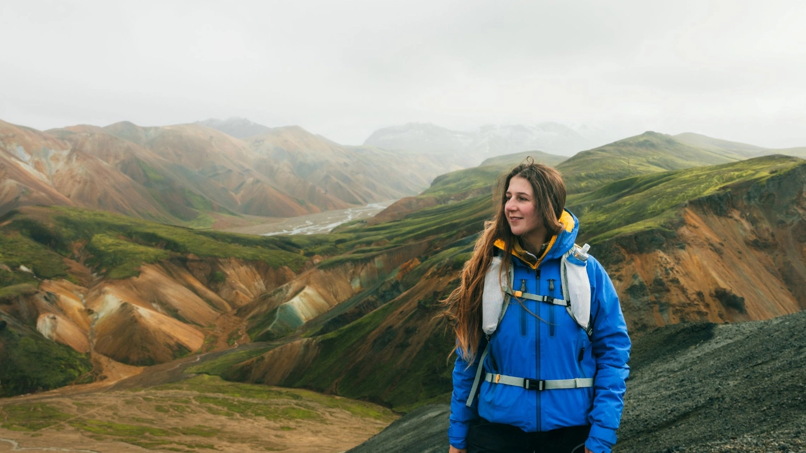 Woman hiking in rainbow mountains of Landmannalaugar, Iceland