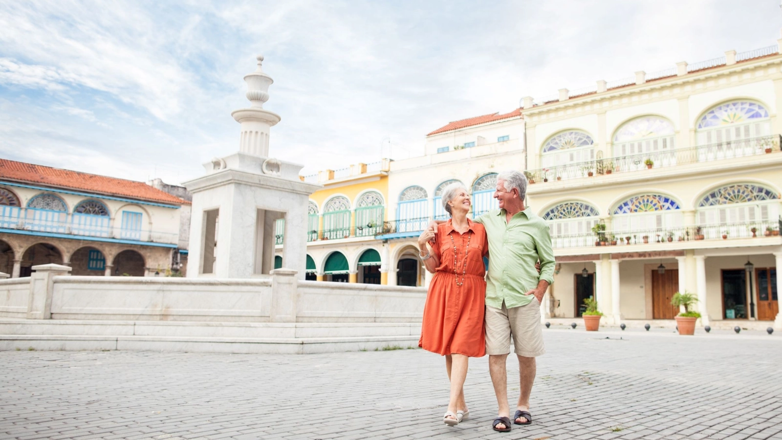 Mature couple walking on the town square