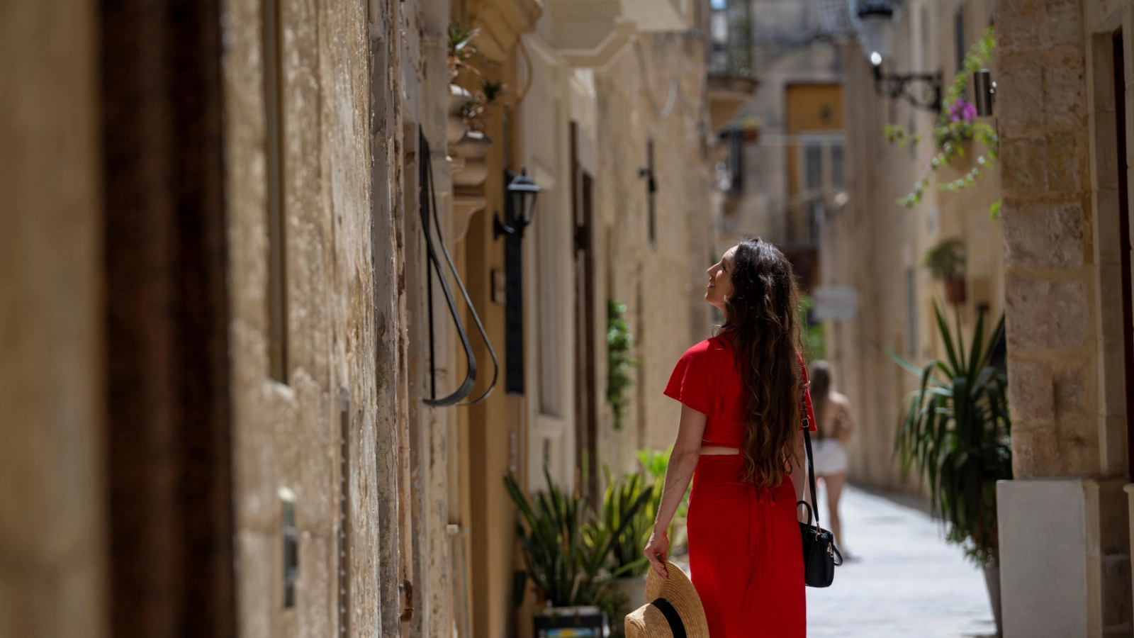 Woman explores narrow streets, Malta