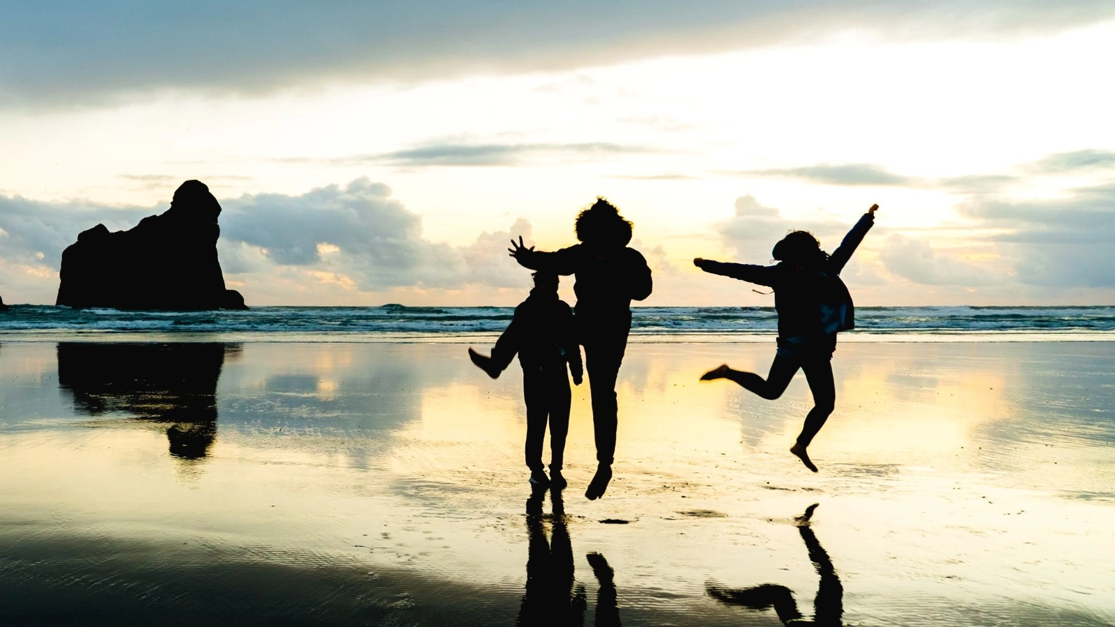 A group of people taking a photo in Wharariki Beach, Nelson, South Island, New Zealand. 