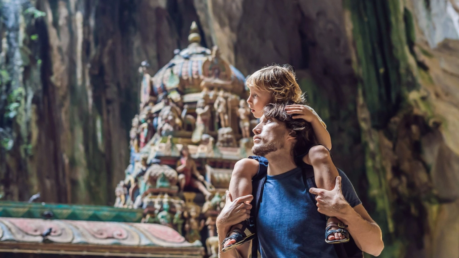 Father and son in the background of Batu Caves, near Kuala Lumpur, Malaysia.