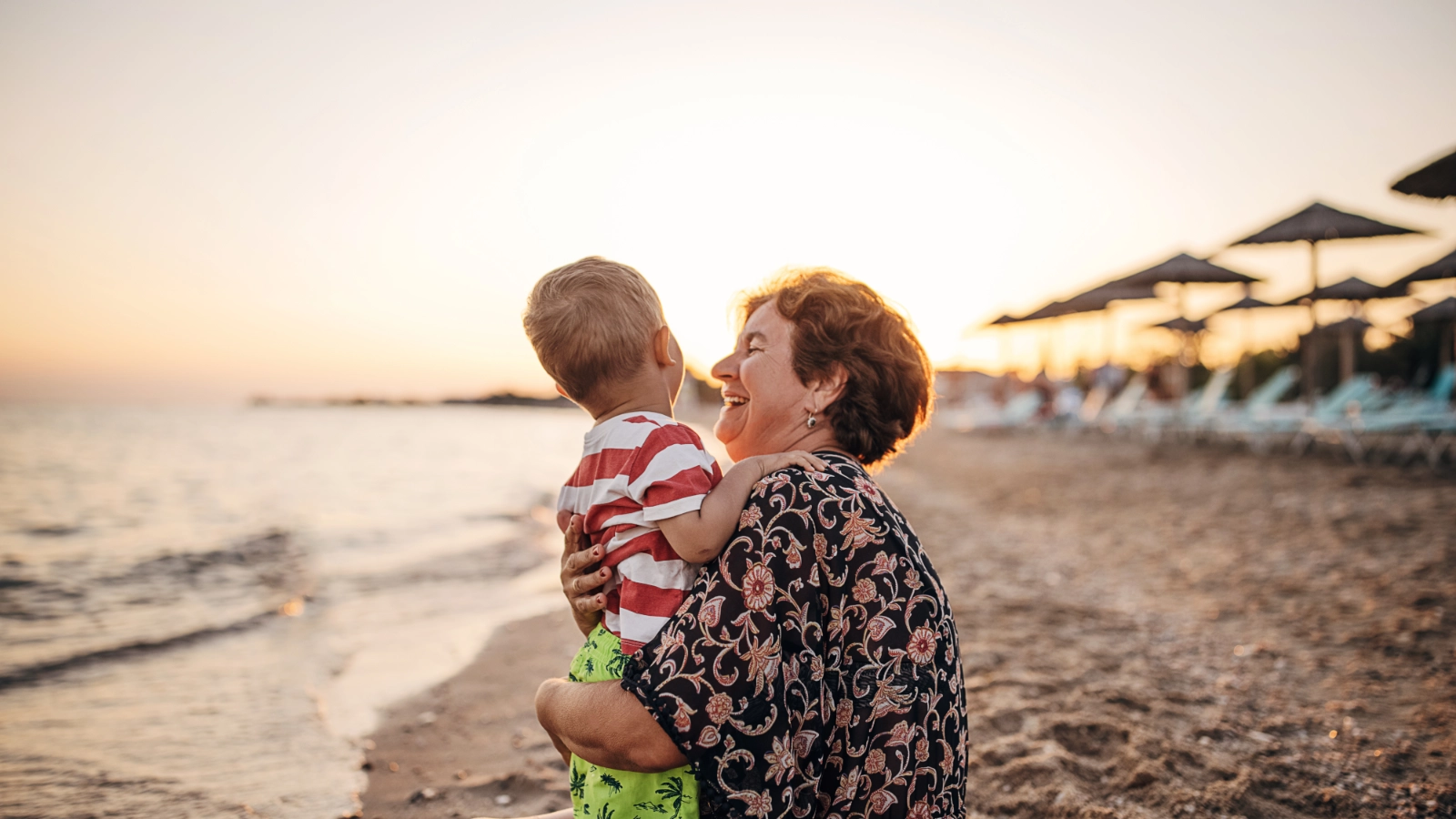 Grandmother and grandson on a sandy beach