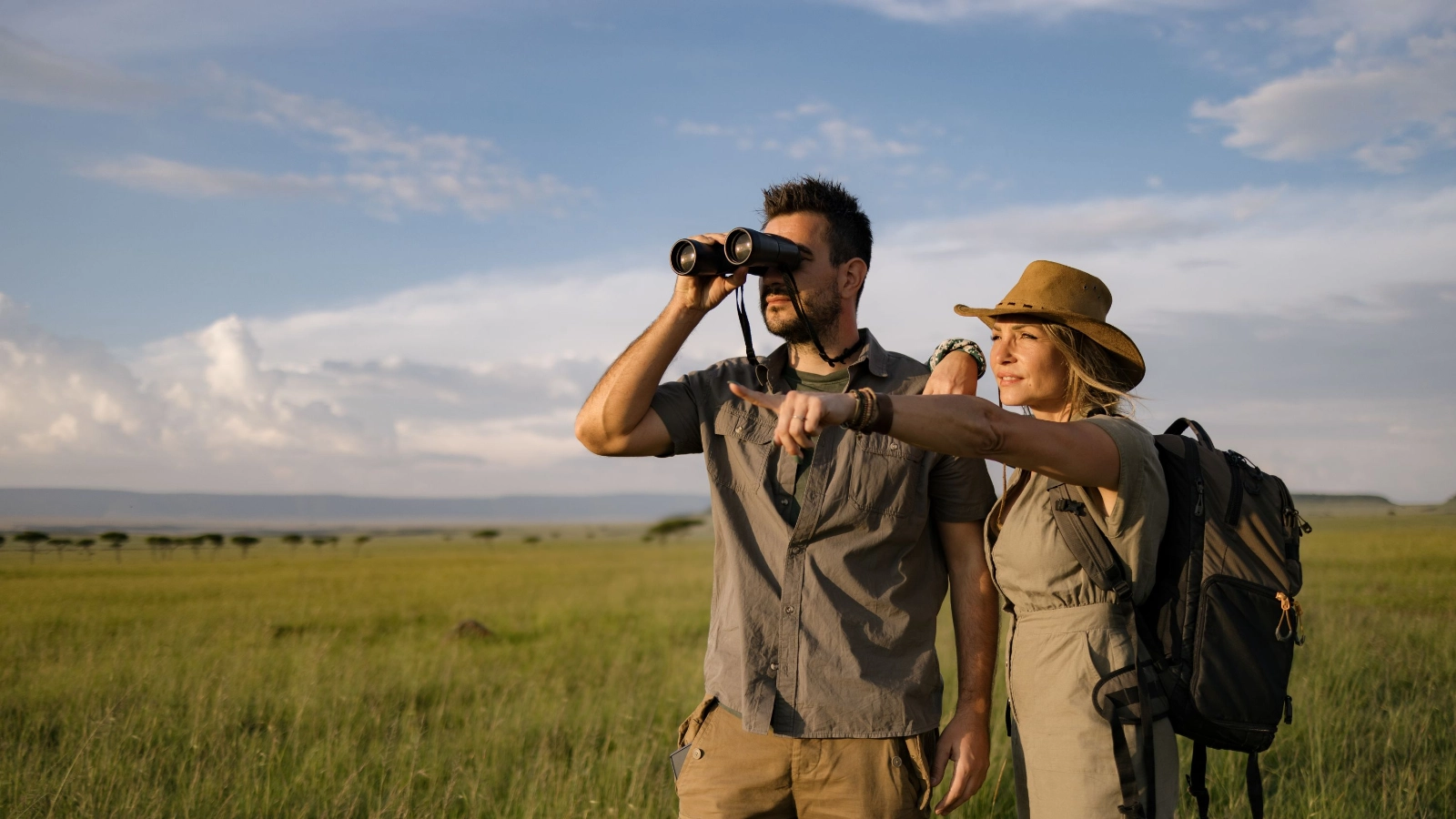 Female tourist showing something in wildlife reserve.