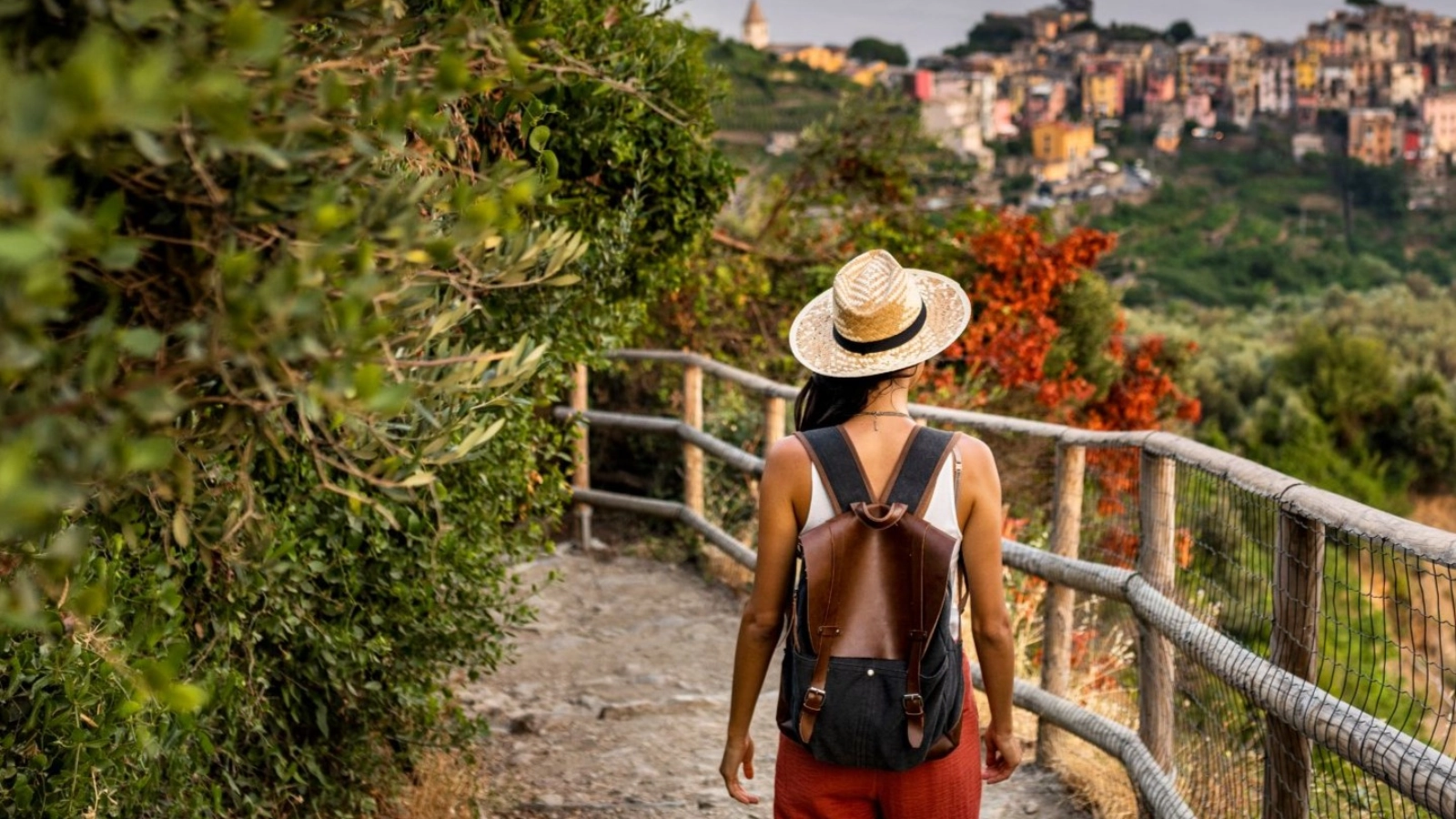 Female tourist walking towards Corniglia village, Beautiful town in Cinque Terre coast.