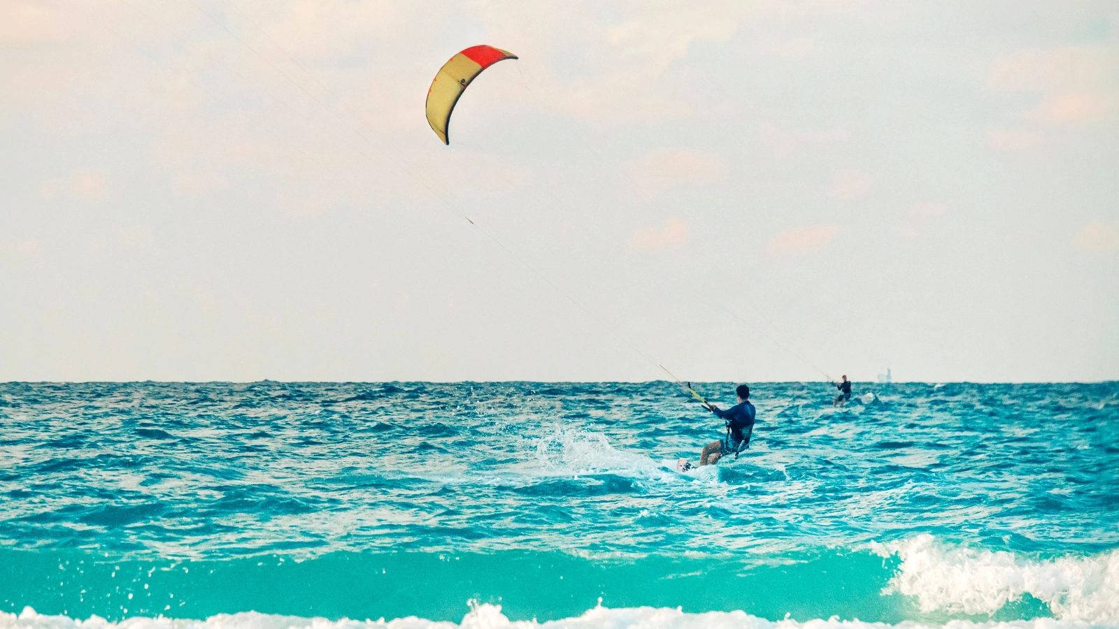Kitesurfer athlete performing kiteboarding tricks