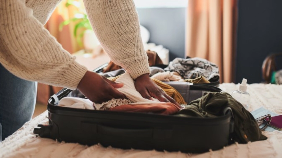 Image of a woman packing a suitcase to travel