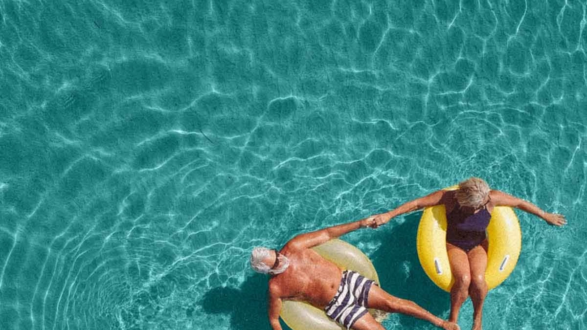 Retired couple relaxing in a pool