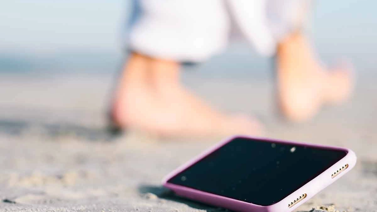A smartphone on a sandy beach