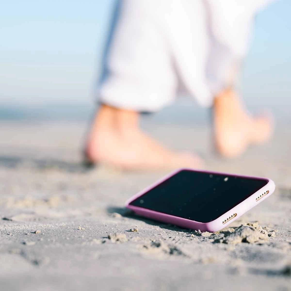 A smartphone on a sandy beach